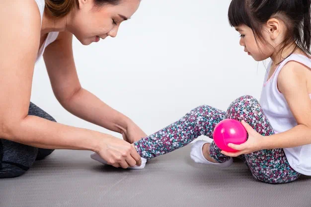 Pediatric physical therapist guiding a child through balance and coordination work at Root Pediatrics in Bozeman, Montana
