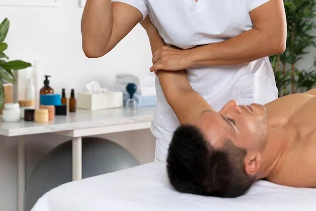Therapist applying gentle, sustained myofascial release to a patient's back at Root Therapy and Wellness in Bozeman, Montana