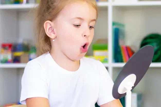 Pediatric speech-language pathologist working with a child on speech sounds and language at Root Pediatrics in Bozeman, Montana
