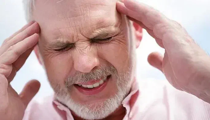 Physical therapist performing gentle upper-neck mobilization for a chronic headache patient at Root Therapy and Wellness in Bozeman, Montana