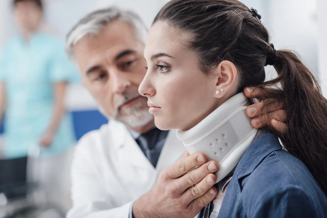 Physical therapist evaluating neck motion after a whiplash injury at Root Therapy and Wellness in Bozeman, Montana